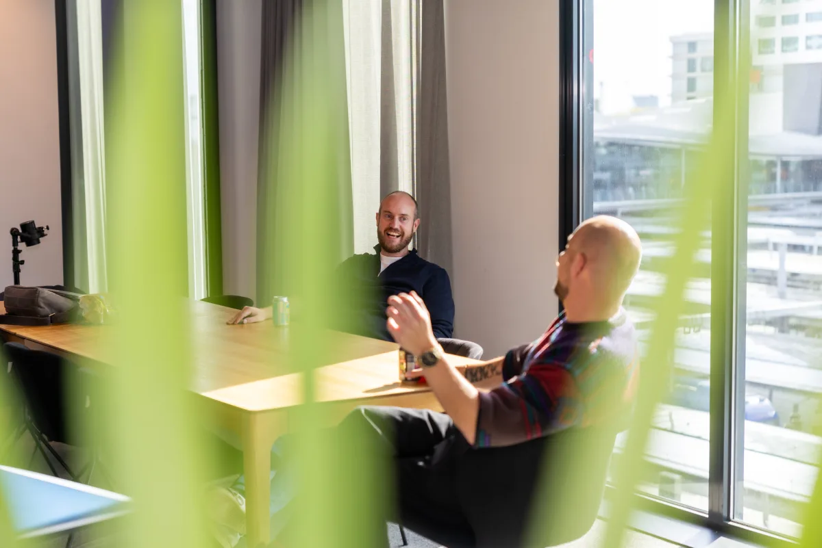 Collega's in gesprek bij het raam op kantoor